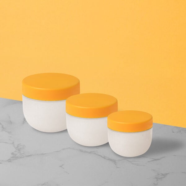 Three white containers with orange lids, including the SWC-JP50CS 50g PP jar, are arranged by size on a gray marble surface against an orange background.