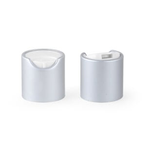 Two 24/410 brushed chrome rose gold caps sit on a white background, echoing the look of elegant cosmetic bottle tops.