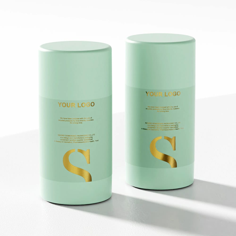 Two mint-green AS deodorant sticks with gold lettering stand side by side on a white surface.