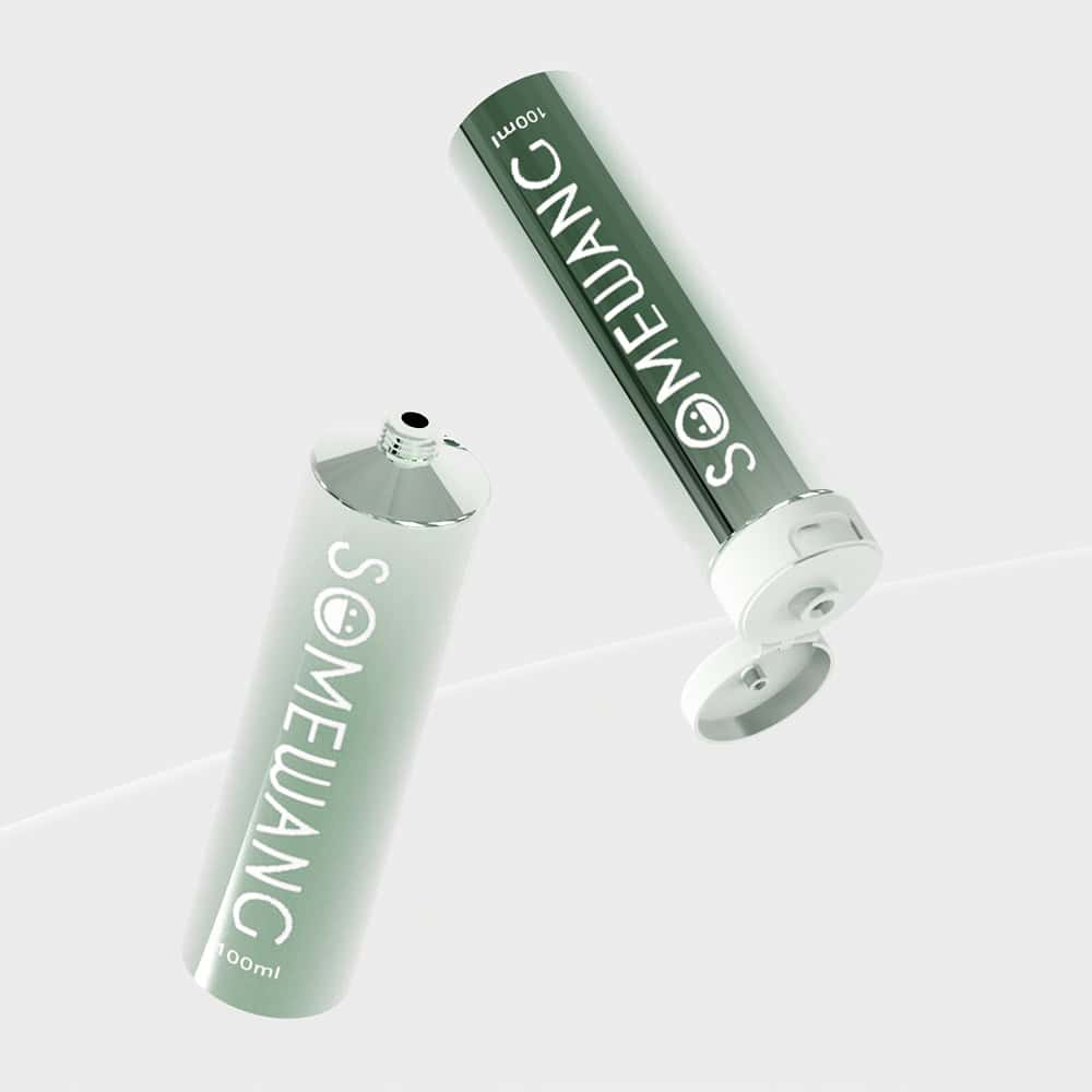 Two green 100ml ABL laminated plastic tubes labeled "SOMEWANG," one open and one closed, displayed on a light background.