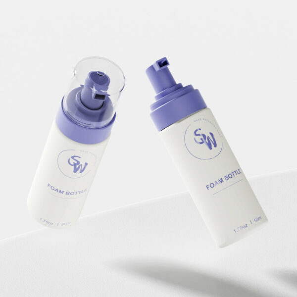 Two 50ml HDPE foam bottles with purple pumps and labels float elegantly against a light gray background.