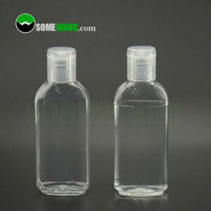 Gri bir arka planda sergilenen, "somewang.com" markalı iki adet 90 ml'lik Kapaklı Şeffaf El Dezenfektanı Şişesi.