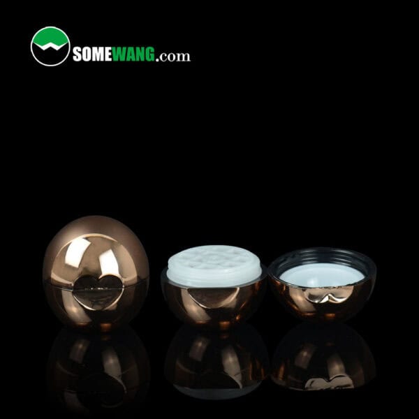 Three bronze SWC-CLI008A 8g ball lip balm containers are shown; one is closed, two open with white interiors. "Somewang.com" logo on top left.