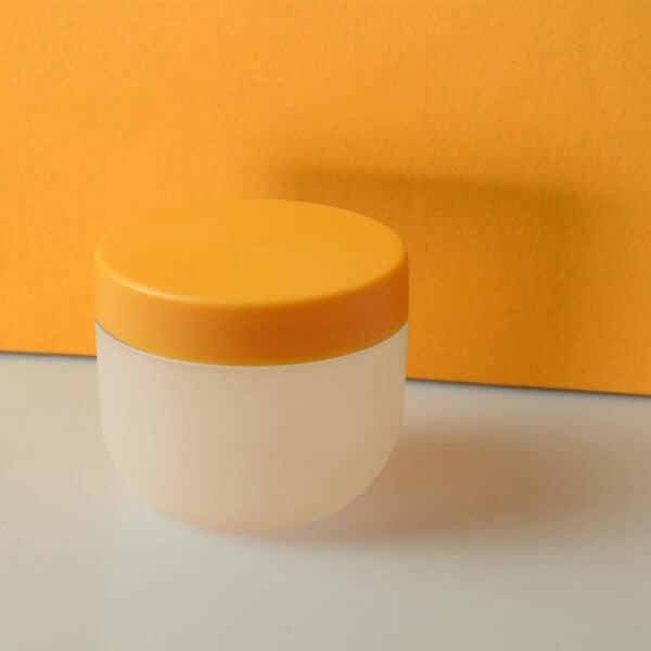 A SWC-JP50CS 50g PP jar with a yellow lid, set against an orange backdrop.