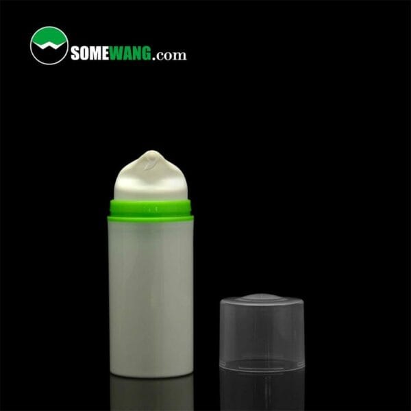 A SWC-BPA10 Plastic PP cosmetic airless pump bottle with a green lid containing a white cream, displayed against a dark background with a transparent cap in front and the logo "somewang.com" at the top.