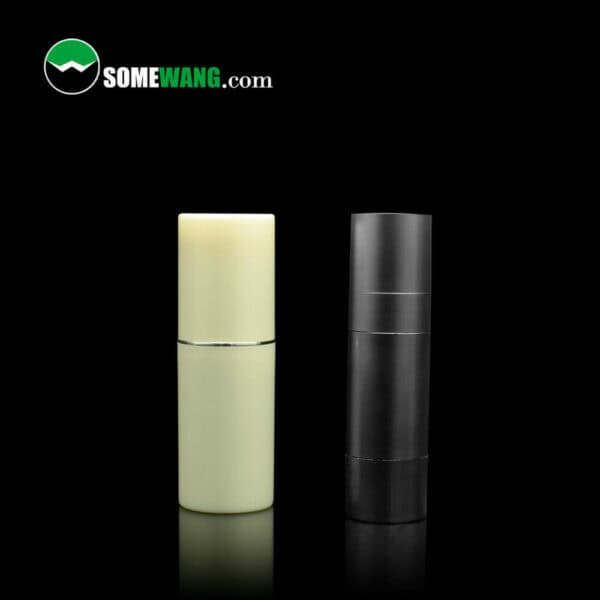 Two SWC-BPA28SC Factory Made AS Airless Pump Bottles, one ivory and one black, against a dark background with the logo "somewang.com" above them.