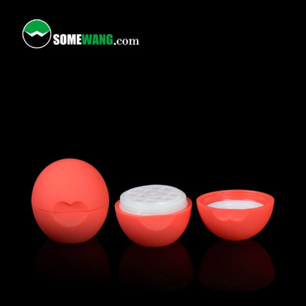 A red ball-shaped lip balm container with white cream inside and the lid off. "somewang.com" and "SWC-CLI008A 8g" are shown on a black background.