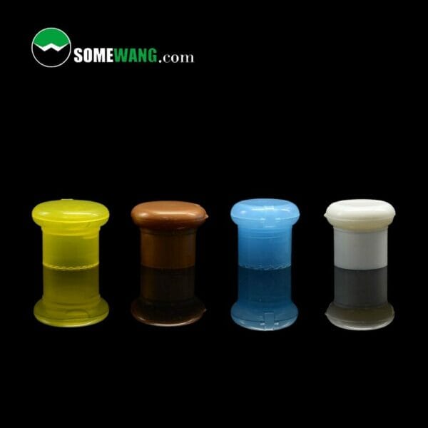 Four colorful plastic cosmetic jars with 24/410 28/410 flip top caps on a black background, each branded with "somewang.com".