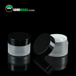 Two SWC-JBG15C 15g PETG cream jars with black lids, one open showing white cream, in a dark background labeled "somewang.com." One jar features a frost finish.