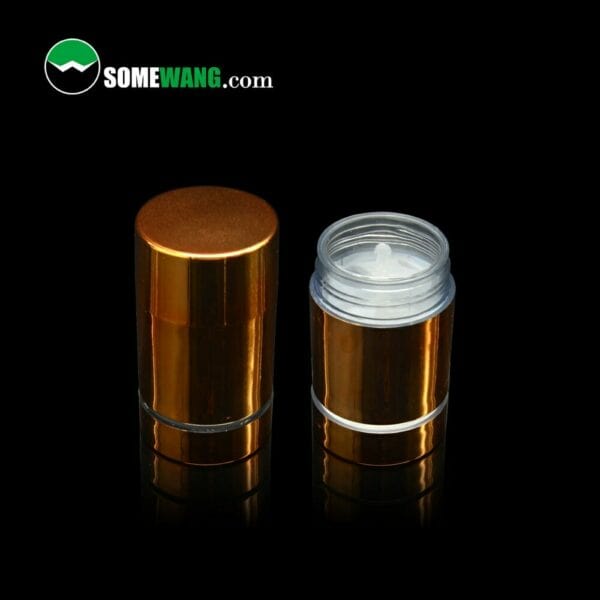 Two Clear AS (BPA Free) Push Up Tube Bottles with bronze finishes displayed on a dark background, one with its cap off revealing the dispenser.