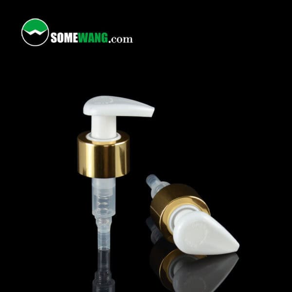 Two white and gold twist-turn lotion dispenser pumps on a glossy black surface with "Somewang.com" logo in the top left corner.