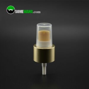 Крупный план маленькой помпы для лосьона Gold 20/410 для пластиковой бутылки с золотистой крышкой на темном фоне, с изображением бренда somewang.com.