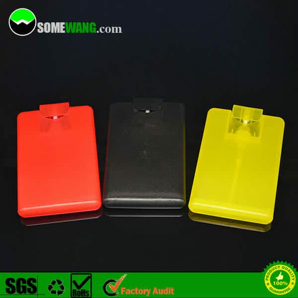 Three colorful plastic containers with flip-top lids, designed for free samples available 15ml credit card antibacterial hand sanitizer waterless alcohol spray pocket bottle, in red, black, and yellow, displayed on a reflective surface.