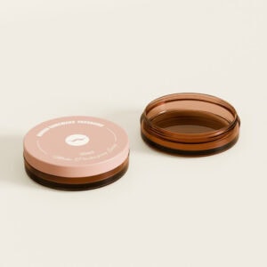 Deux pots ronds en plastique marron à double paroi de 30 ml : l'un ouvert, l'autre fermé avec un couvercle rose étiqueté « 30 ml » et « Emballage cosmétique ».