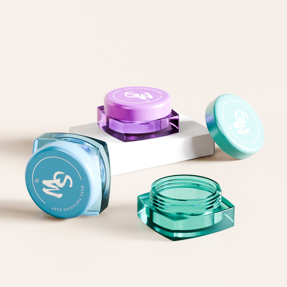 Three hexagonal SWC-JPS3JS 3g eyecream jars—purple, blue, and green—sit on a neutral background; two are open.