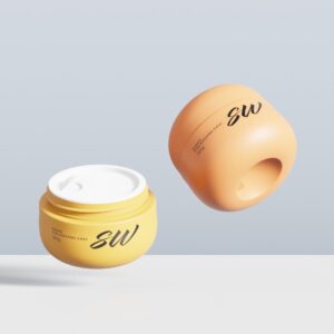 Two 30g "SW" cream jars—one open yellow, one closed orange—sit on a light background with minimalist labels.