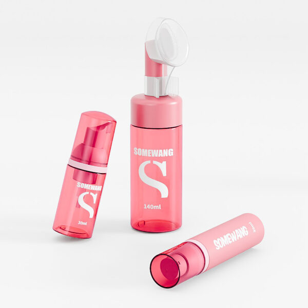 Three pink "Somewang" bottles—a 30ml foam pump and two 140ml—are elegantly arranged on a pristine white surface.