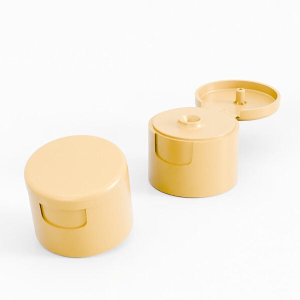 Two beige PP 28mm flip-top caps (one open, one closed) for body milk on a white background.