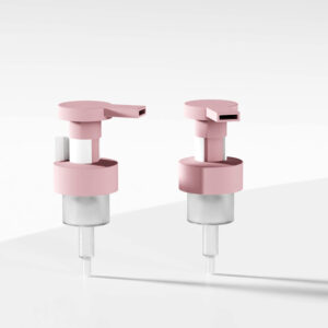 Two pink and silver 40/410 PP plastic foam soap pumps with internal springs sit elegantly on a white surface, showcasing minimalism.