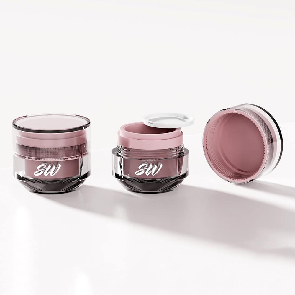 On a white surface, three 50ml luxury acrylic jars hold pink cream; they have double walls and two lids nearby.