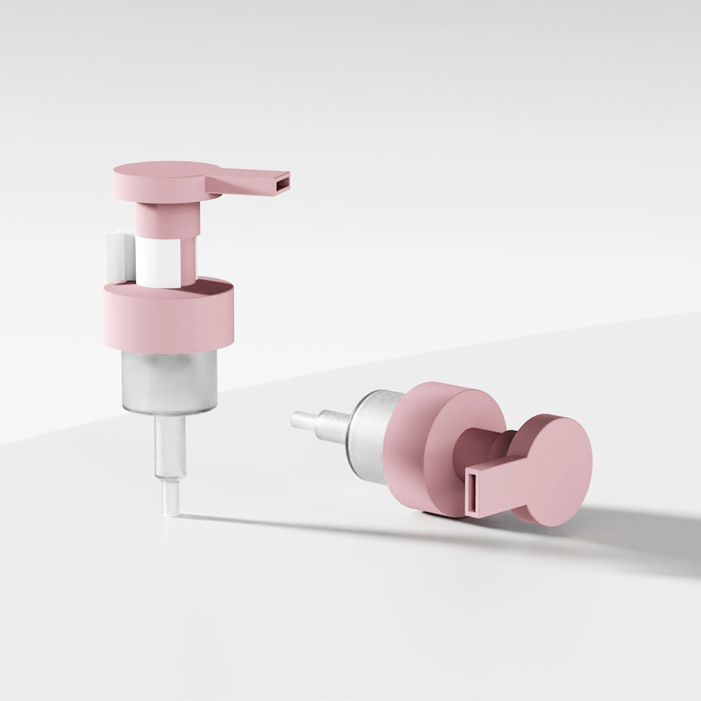 Two pink and silver 40/410 PP plastic foam soap pumps sit on a white surface, one upright and the other lying down.