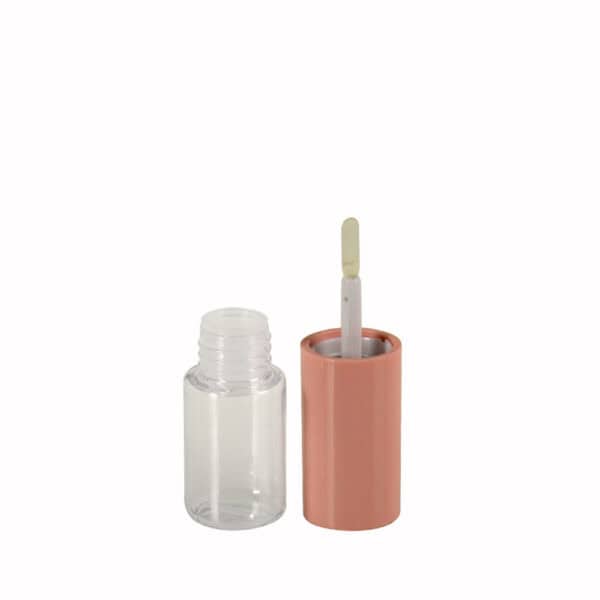 A transparent nail polish bottle with a peach cap is open, showing the brush. Its elegant design resembles high-end cosmetics packaging.