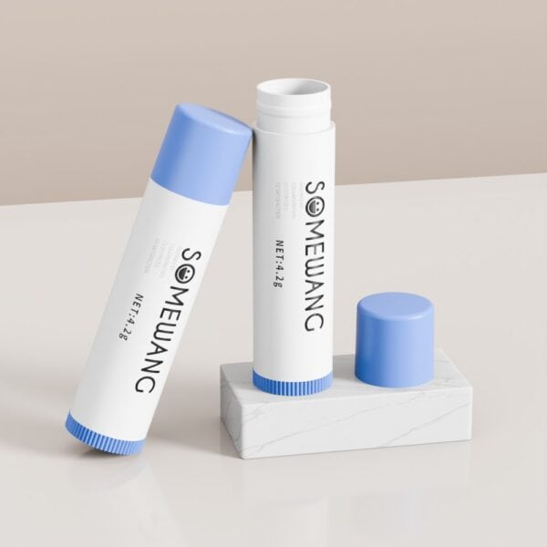 Two 4.2g PP oval lip tubes with blue caps and "SOMEWANG" branding rest on a marble-textured holder.