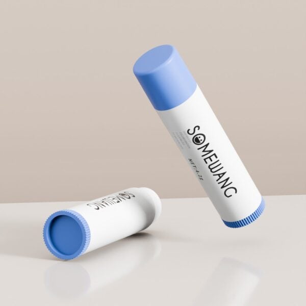 Two 4.2g PP oval lip tubes with blue caps—one upright, one on its side—on a reflective beige background.