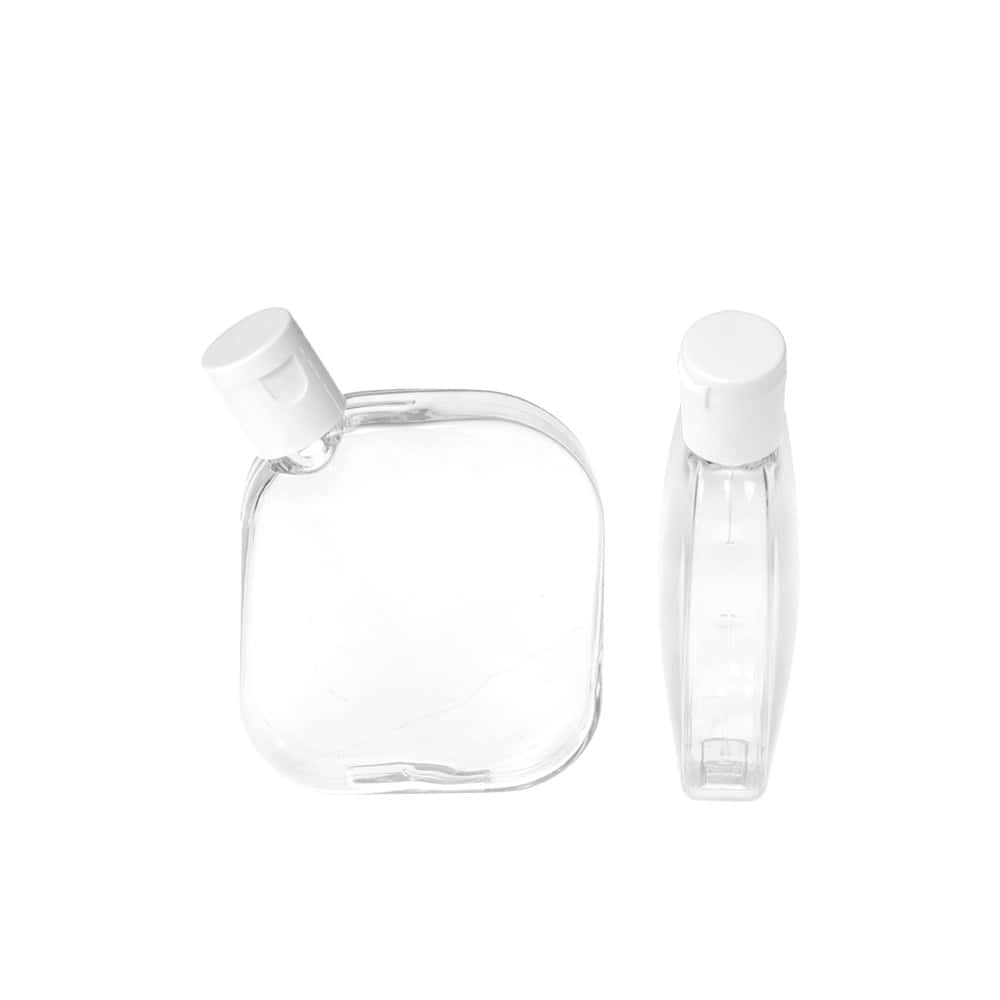 Two empty, transparent 100ml PETG rectangular shaped bottles with white caps on a white background, one bottle upright and the other lying down.