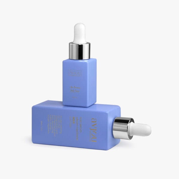 Due flaconi contagocce per essenza rettangolari blu da 50 ml con tappi argentati sono impilati, uno verticale e uno orizzontale, con testo dorato.