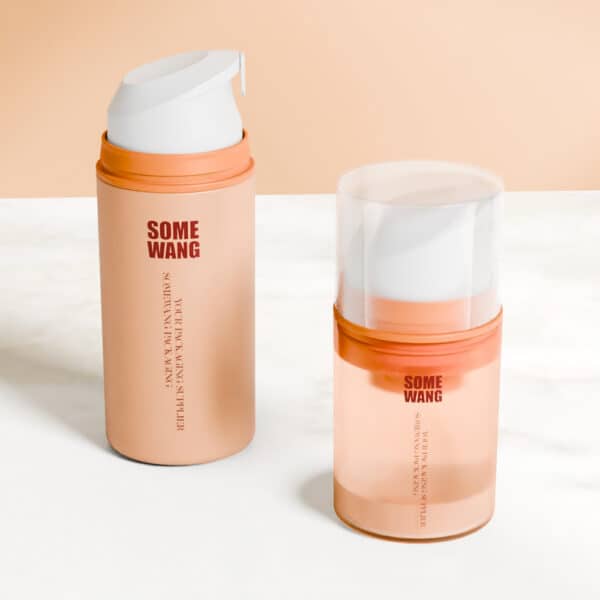 Two cylindrical skincare bottles with orange accents. One has a 50ml airless pump, the other a clear cap, shown against a neutral background.