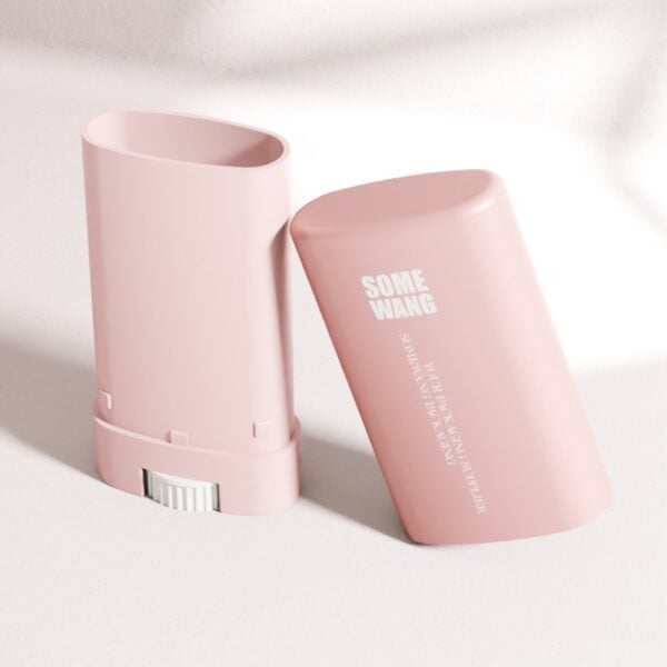 A pink rectangular deodorant stick tube labeled "15 ML PP Twist-Up" lies next to its detached pink cap.