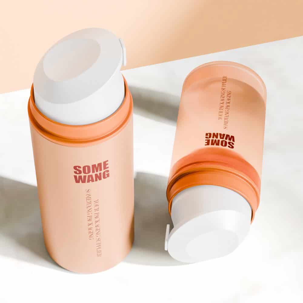 Two opaque orange and pink 50ml facial cream bottles with pumps rest on a light marble surface, labeled "SOME WANG".