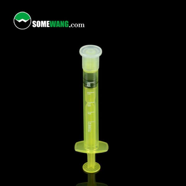 A bright yellow veterinary syringe for cow mastitis medicine with clear markings and SOMEWANG.com logo on a black background.