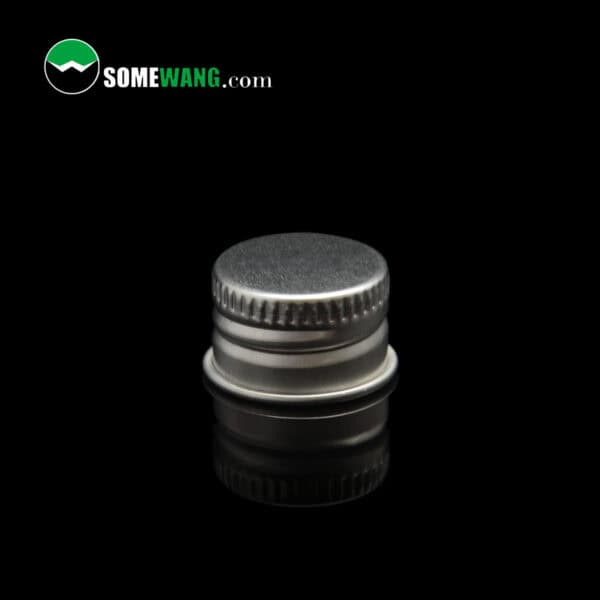 Travel size SOMEWANG 30ML LDPE bottle cap on a reflective surface with the text "somewang.com" visible, set against a dark background.