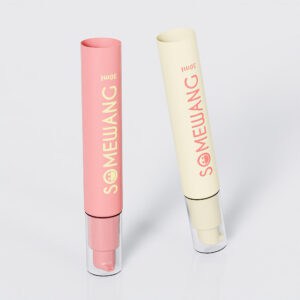 Two 30ml "SOMEWANG" cylindrical lotion bottles, pink and beige, stand upright on a gray background, resembling sleek PE Airless tubes.