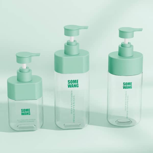 Three transparent pump bottles with green caps and "500ml PET for personal care" labels on a light green background.