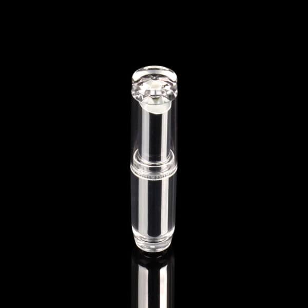 A clear SWC-CLI004A lipstick tube with a diamond-shaped top stands upright against a black background.