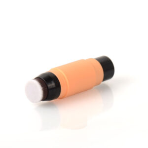 The Cheap Makeup Brush, with an orange and black tube and built-in tip, sits on a white surface.