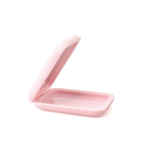 An open, empty pink container with rounded corners and a hinged lid, like an SWC-CMF022 blush case with mirror.