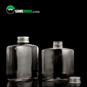 Two clear 250ML PET SOMEWANG bottles with silver lids are on a reflective black surface. "SOMEWANG.com" above. Ideal for shampoo or shower gel.