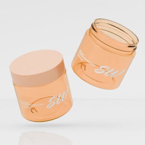 Two PET Plastic Amber Jars for Skincare with lids, one upright and one tilted, featuring "SW" text, reflecting light on white.