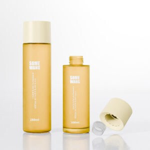 Two yellow PET plastic bottles (100ml & 150ml, neck size 24/410) are displayed elegantly against a light background.