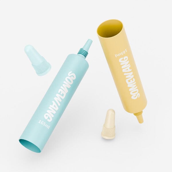 Two toothpaste tubes, one blue and one yellow, made from PE Round Tube with volume customization. Caps are placed nearby on a white background.