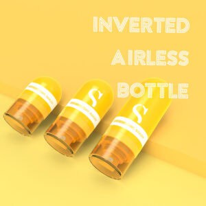 Three yellow eco-friendly airless cosmetic bottles, made from biodegradable wheat straw plastic, sit against a matching background.