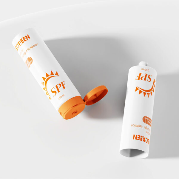 Two sunscreen tubes with orange caps labeled "SPF" and an open 350ml cosmetic lotion tube lie on a white surface.