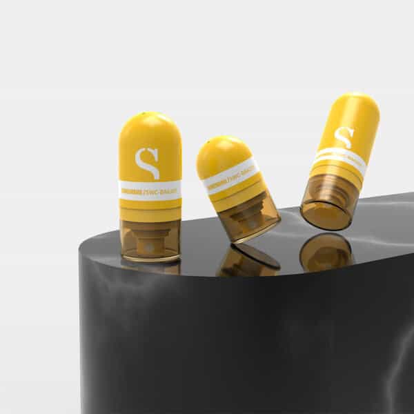 Three translucent yellow-brown capsules rest on a glossy black surface; two upright, one tilted.