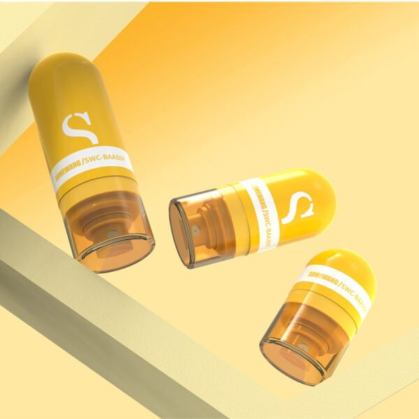 Three yellow eco-friendly straw wheat cosmetic tubes with branding rest on a slanted surface against a vibrant yellow background.