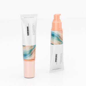 Two eco-friendly wheat straw cosmetic tubes with peach caps and abstract design labels are shown on a white background.