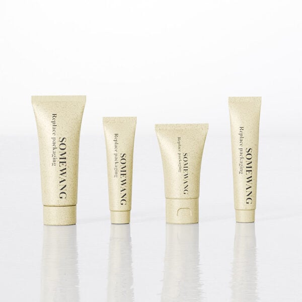 Four beige "Somewang" skincare tubes (D40mm, D16mm, D25mm, D19mm) sit aligned on a reflective surface.